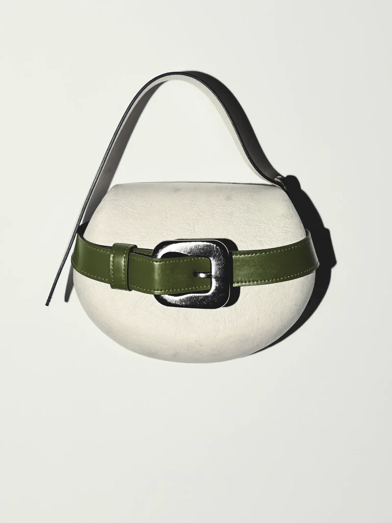 Illustration: kompakte Halbmond-Crossbody mit eigenem Verschluss